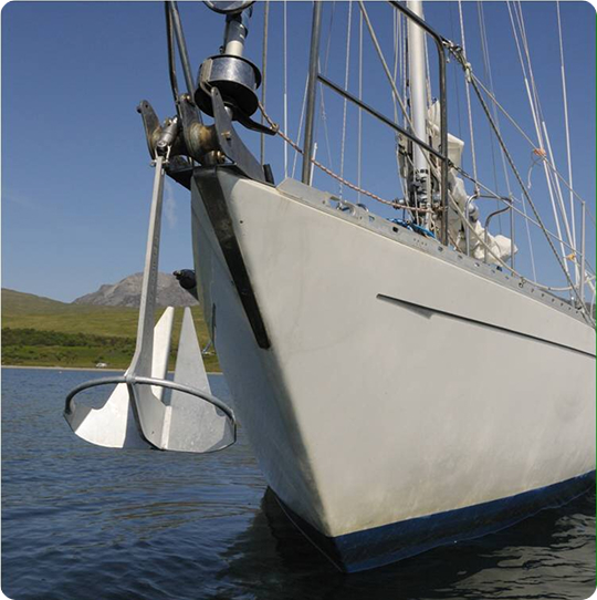 Close-up of a Knox anchor stowed securely on the bow roller of a sailboat.