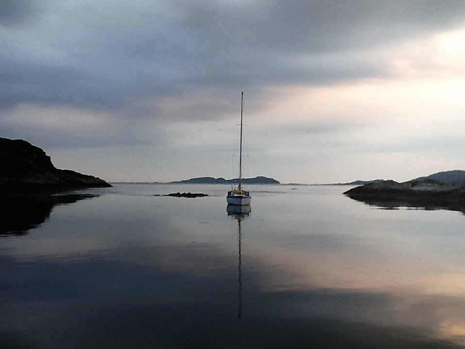 a boat on the water anchored by Knox