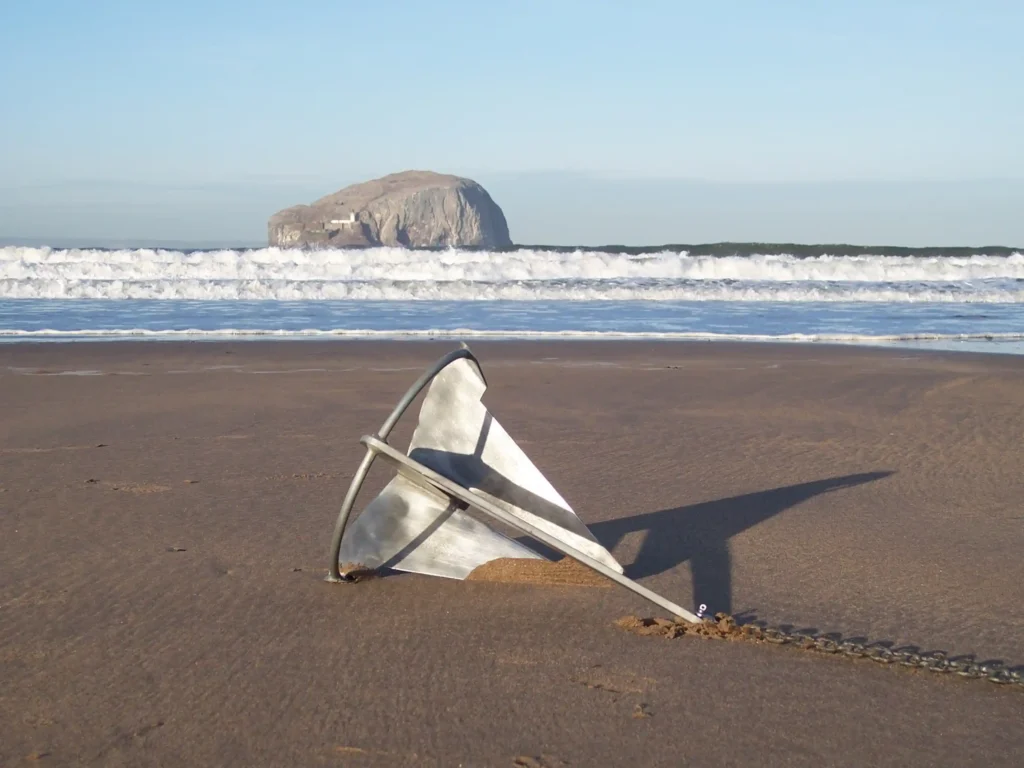 Split Fluke Designed Anchor resting on the beach