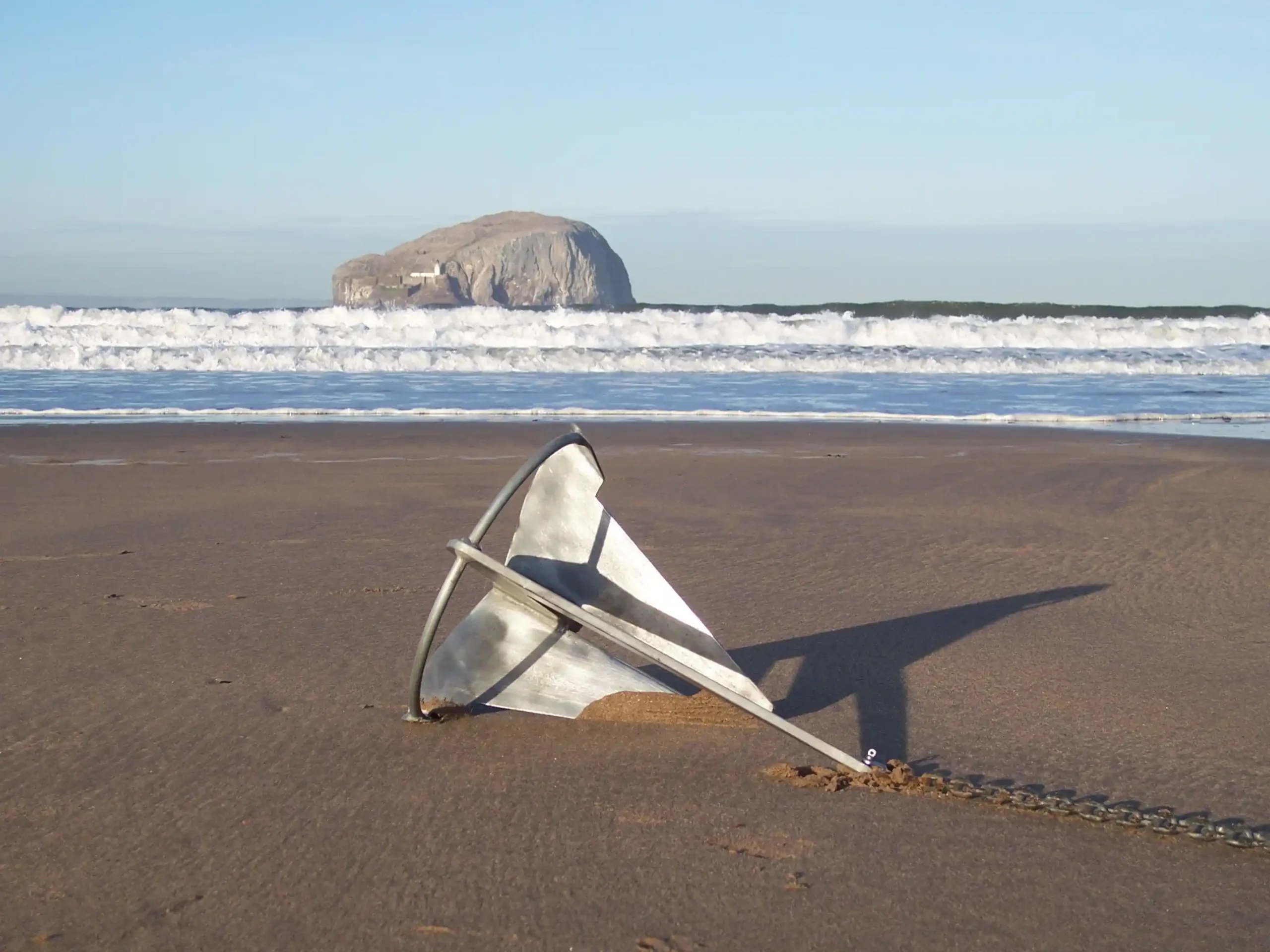 Split Fluke Designed Anchor resting on the beach